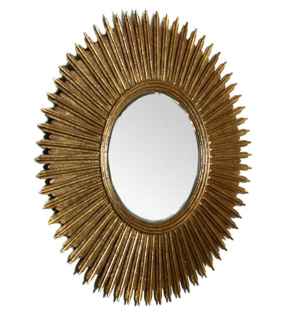 This is an exceptionally large and dramatic mirror.  It was probably made in Mexico.  The mirror is in very good shape and is beveled.