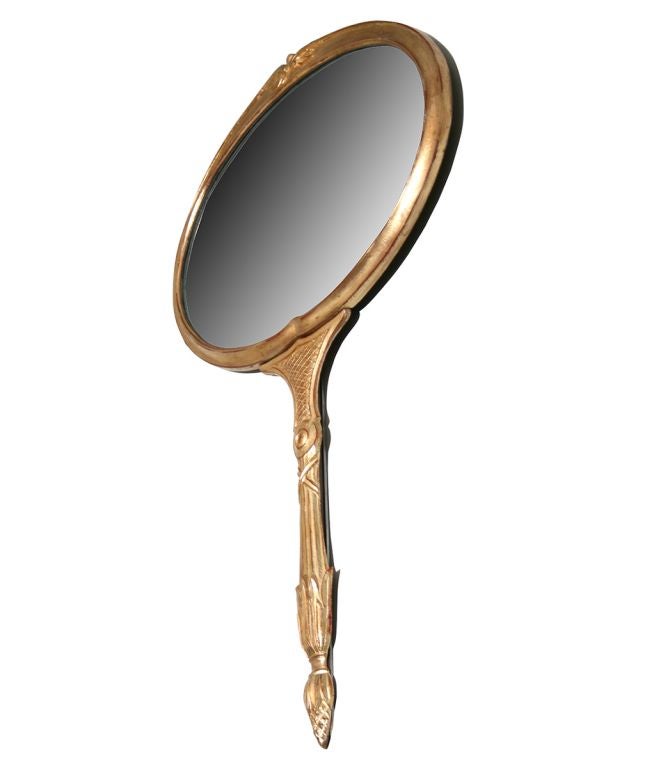 This Palladio wall mirror, in the shape of a hand mirror, is very whimsical and has nice detailing.