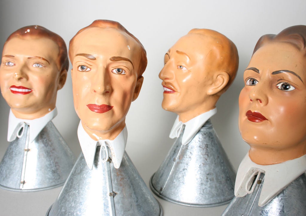 These finely done mannequin heads are from a 1920's department store display that modeled ties. Incredibly, each face has different characteristics.  They are displayed on metal funnels.