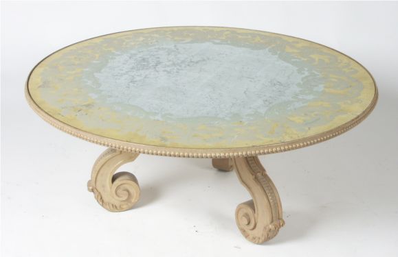 Baker 1940s cocktail table with reverse painted glass top and bleached mahognay scroll legs and top surround