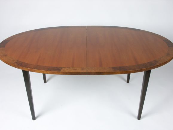 Dining table with ebonized legs, oval top with burl wood edge, 3 leaves,6 foot without leaves,  11 foot long when fully extended,( three 20 inch leaves)