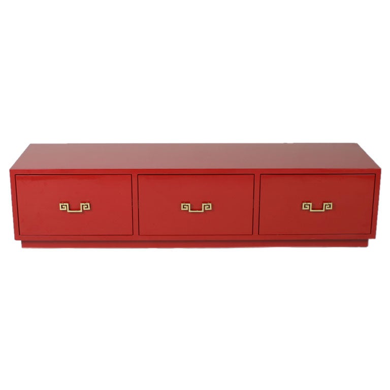 Low red lacquer chest of drawers in style of Tommi Parzinger