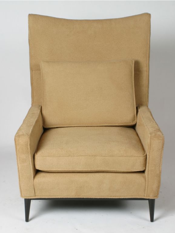 Pair of high back Paul McCobb club chairs in camel cashmere type upholstery with tapered mahogany legs.