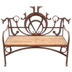 WROUGHT IRON AND OAK BENCH FROM THE ESTATE OF  JOSE THENEE