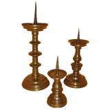 Set of three antique brass candlesticks