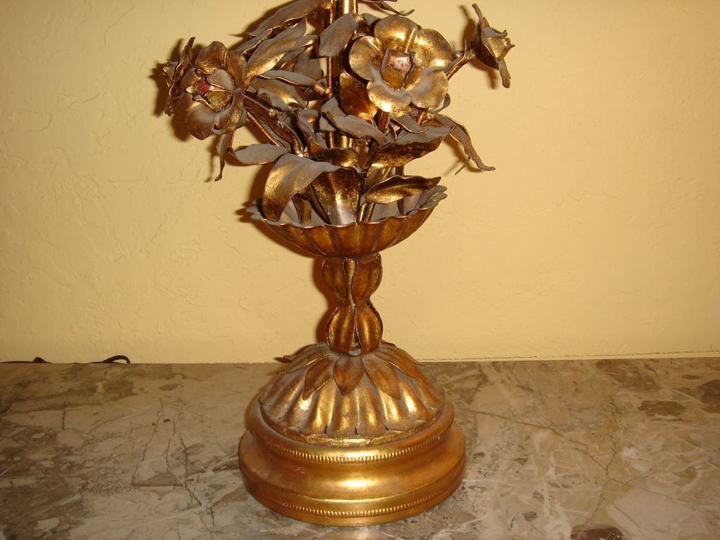 An Italian gilt metal single lamp, floral motif with wooden base. Hanf made great for a desk or bedroom side table lamp