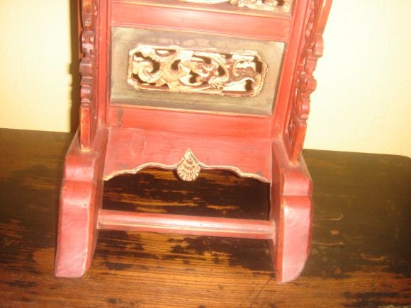 A pair of Chinese carved wood, red lacquer free standing adjustable height candlesticks with gilt wood accents