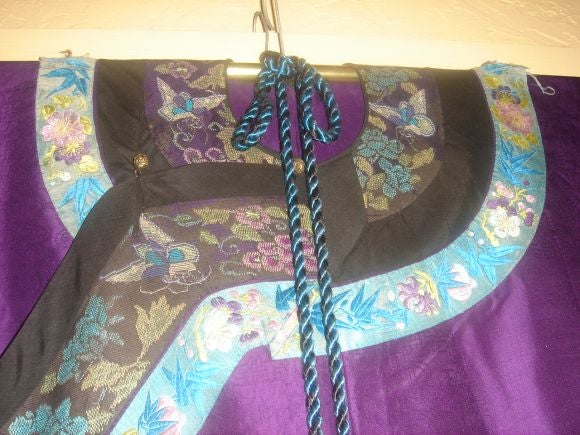 A Mongolian court robe worn on special occasions, Peking style stitch, clipped stitch medallion design on purple silk