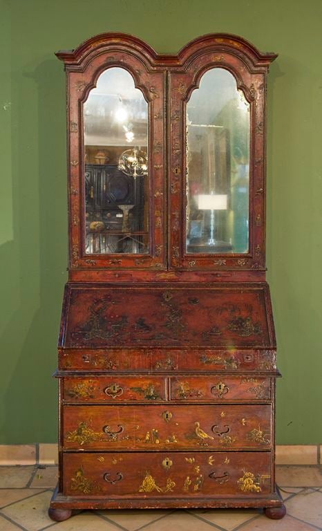 An exuberant Queen Anne vermillion-japanned double-domed Bureau Cabinet; it's inner surfaces highly re-decorated in the 1850's in Mugal Motif:  Allegories to the continents, Bear Hunts, Alexander and Roxanne conquering India with Elephant.<br