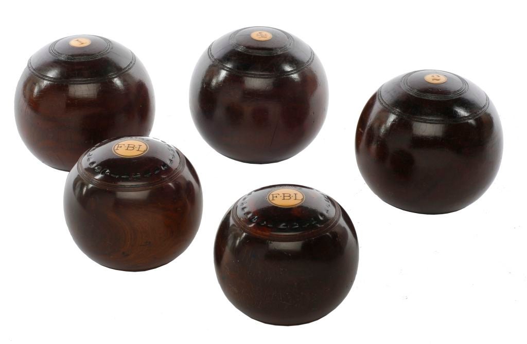 Exquisite set of mahogany and inlaid bone bocce balls with engraved letters
