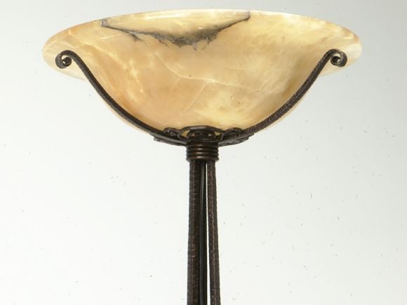 A stunning French hand-forged and sculpted iron torchiere with it's original alabaster shade. From its three scrolled feet upward towards its phenomenal alabaster shade are the most amazing curlicues, I have ever seen. Though we have looked, we