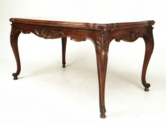 Exceptional vintage walnut draw leaf table with elegant carvings and an outstanding top.  Each leaf is 20