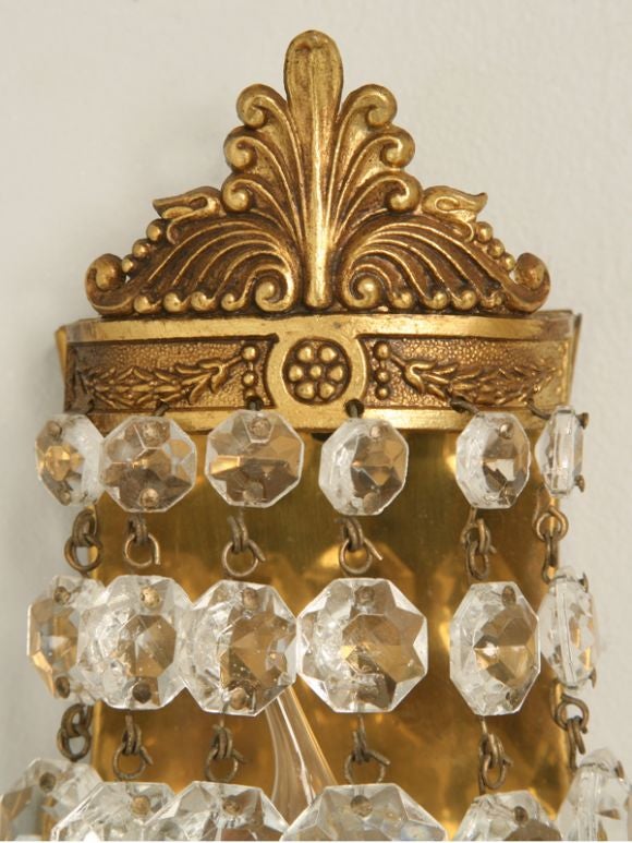 Unusual pair of petite brass and crystal basket form wall sconces rewired.