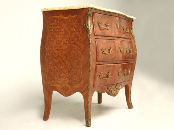 Antique French marquetry bombe chest with three drawers, bronze trim and hardware and the original marble top.