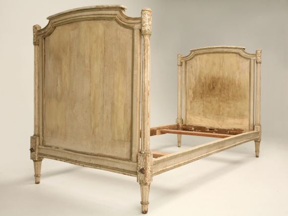 Louis XVI style day bed with original paint, completely hand-carved and has a great classic look. The detail on the posts is very unusual for the Louis XVI style.