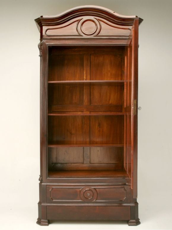 Antique Louis Philippe style single-door amoire in beautiful rosewood, with a bonnet top, carved accents, and a hand dovetailed drawer.