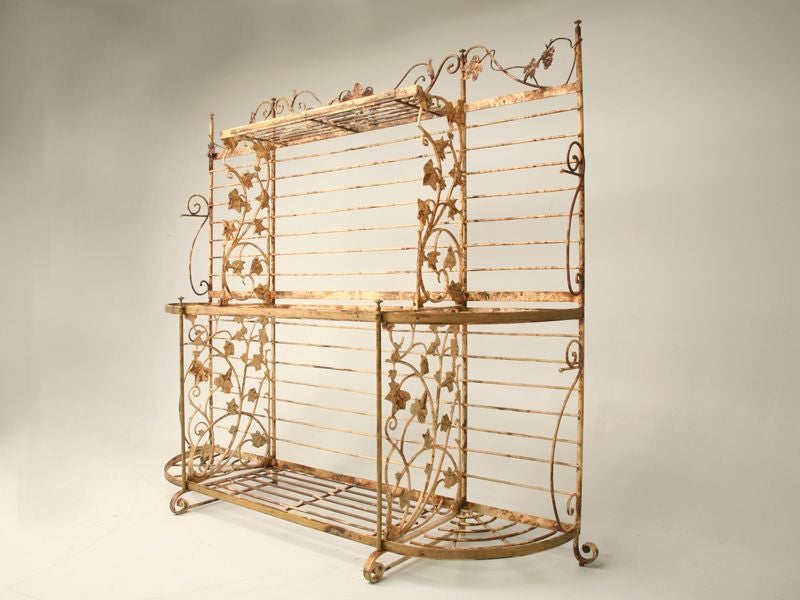 Vintage French baker's rack made from steel with original distressed paint and decorative vine motif.  Price includes custom made polished stone shelf inserts (not shown)-we are happy to email pictures with the stone to you upon request.