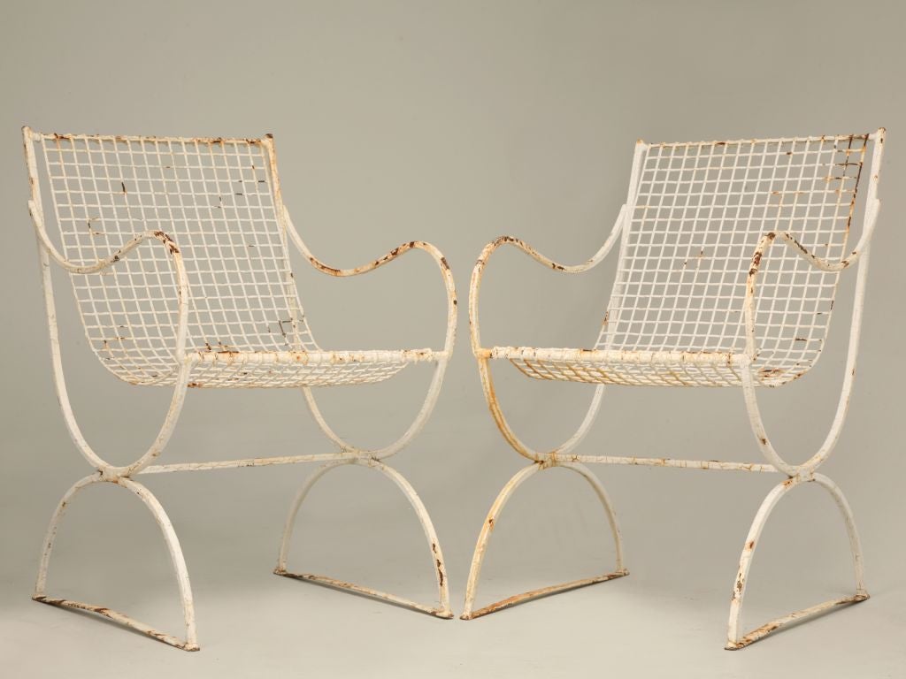 Five pieces of vintage French wire mesh garden furniture. There is one chaise, two arm chairs and two straight chairs. A classic of modern design.