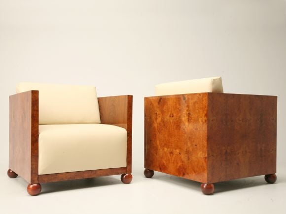 Pair of early Art Deco burled walnut chairs in cube form. The original reclining frames are still intact. The sides feature book-matched walnut. Attributed to Andre Leon Arbus. We have a copy of the original Arbus bill, when these were purchased in