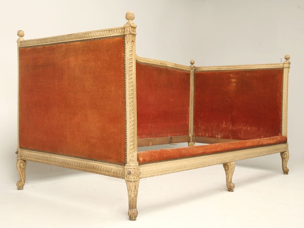 Antique Louis XV style day bed with the original paint that has never been touched-up and the original mohair. All hand-carved with beautiful and intricate details. This day bed could also double as a sofa. Very classic proportions.