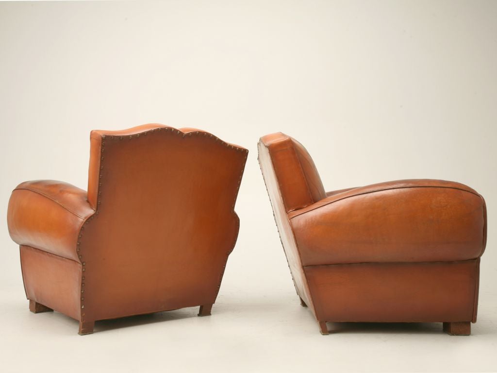 Pair of vintage French mustache back club chairs with original leather. They sit great-very comfortable. A matching settee is available.