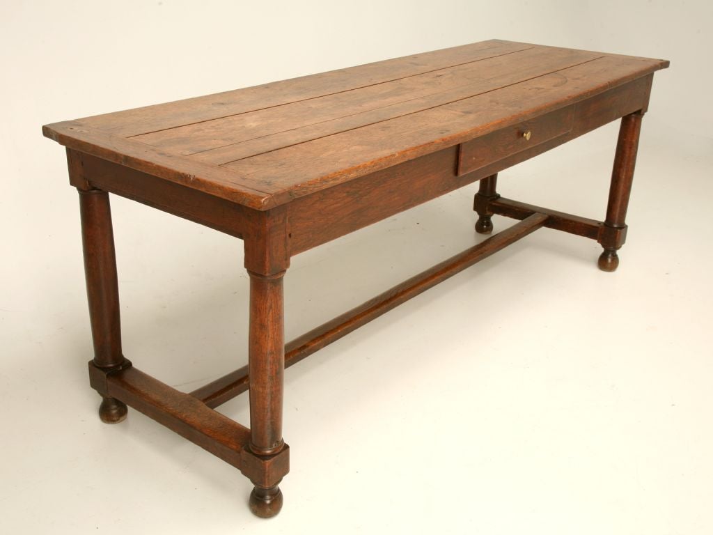 Antique French farm house table made from French oak with wooden peg construction, breadboard ends on the top, a hand-dovetailed drawer and a beautifully worn stretcher from 200 years of being used as a dining table. Still retains the wonderful