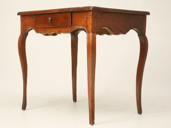 Breathtaking antique French walnut desk or side table with a single drawer, delicate hand-carved cabriolet legs and scalloped apron, too. This table exemplifies all the characteristics and charm you could ever hope for. This table is a true
