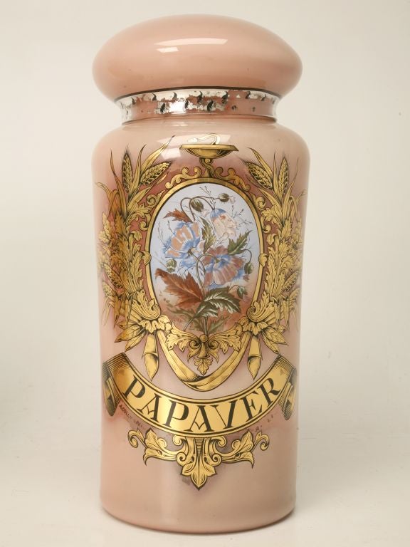 Hard-to-find pair of gigantic apothecary jars used as a French pharmacy store display. They are made from mouth-blown glass and have been painted and gilded by hand from the inside. Now that takes patience! The inscriptions read 