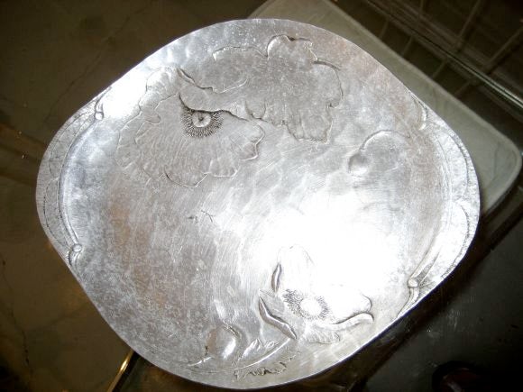 This Wendell August aluminum tray is forged and hammered with a thistle motif.  It is marked Wendell August Forge 560.