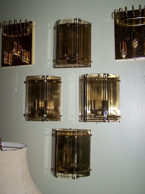 1960s set of four Italian sconces with brass frame. Each sconce has two lights.
