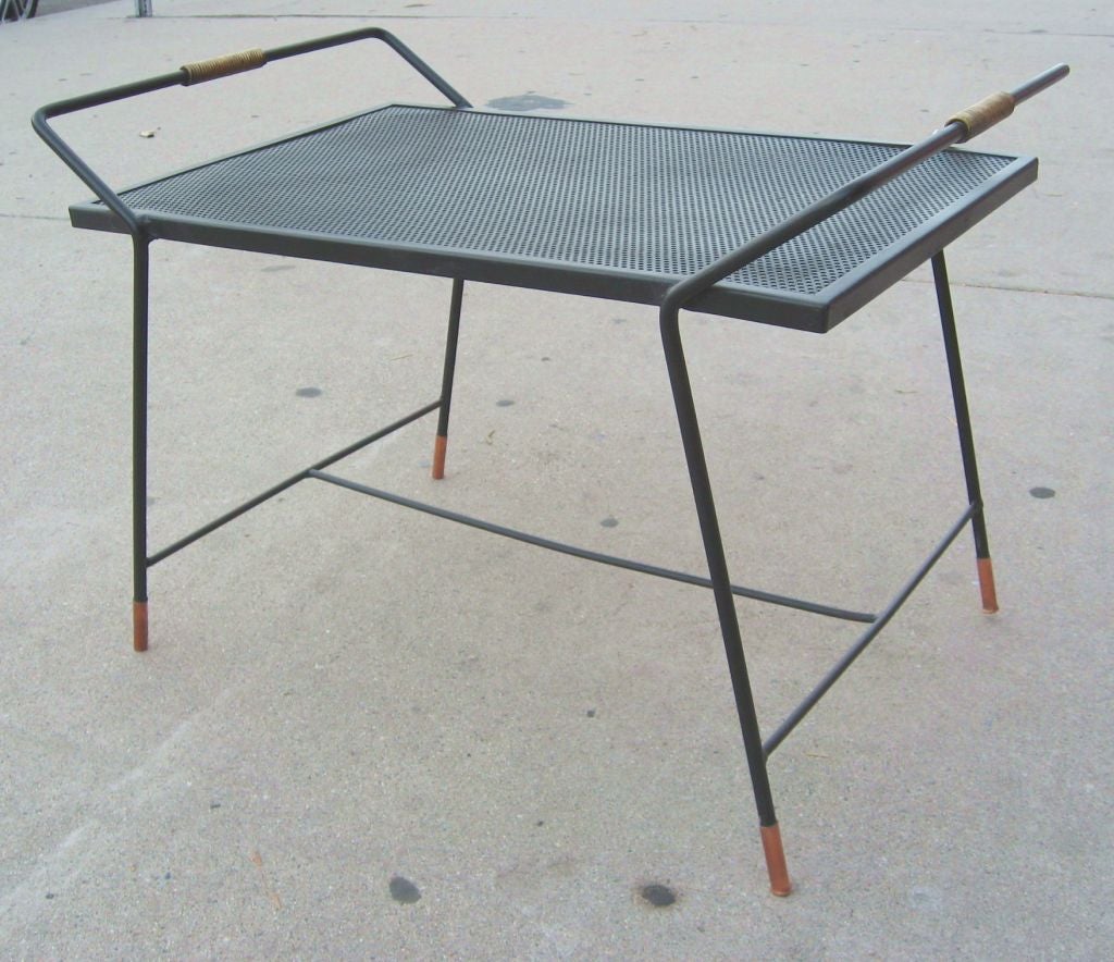 Perforated iron side table By Mathieu Mategot