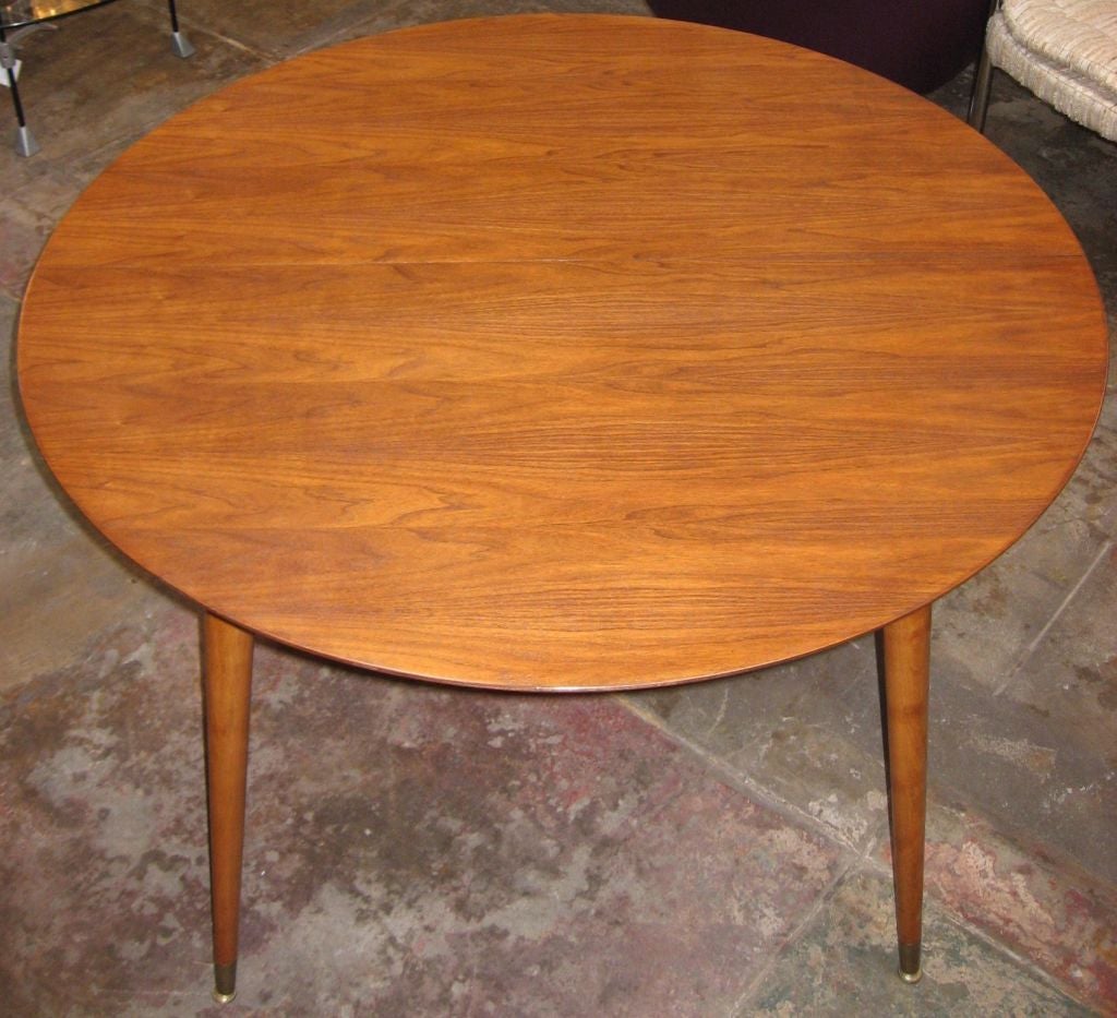 Round walnut dining table with 1 extention. <br />
The 4 walnut caned back chairs matching are available .