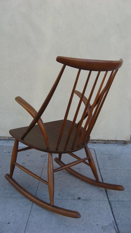 Note the whimsical and unusual arms rest.<br />
The design of tis rocking chair reminds Nakashima.