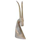 Antelope`s head wrapped in fossilized stone with brass antlers .