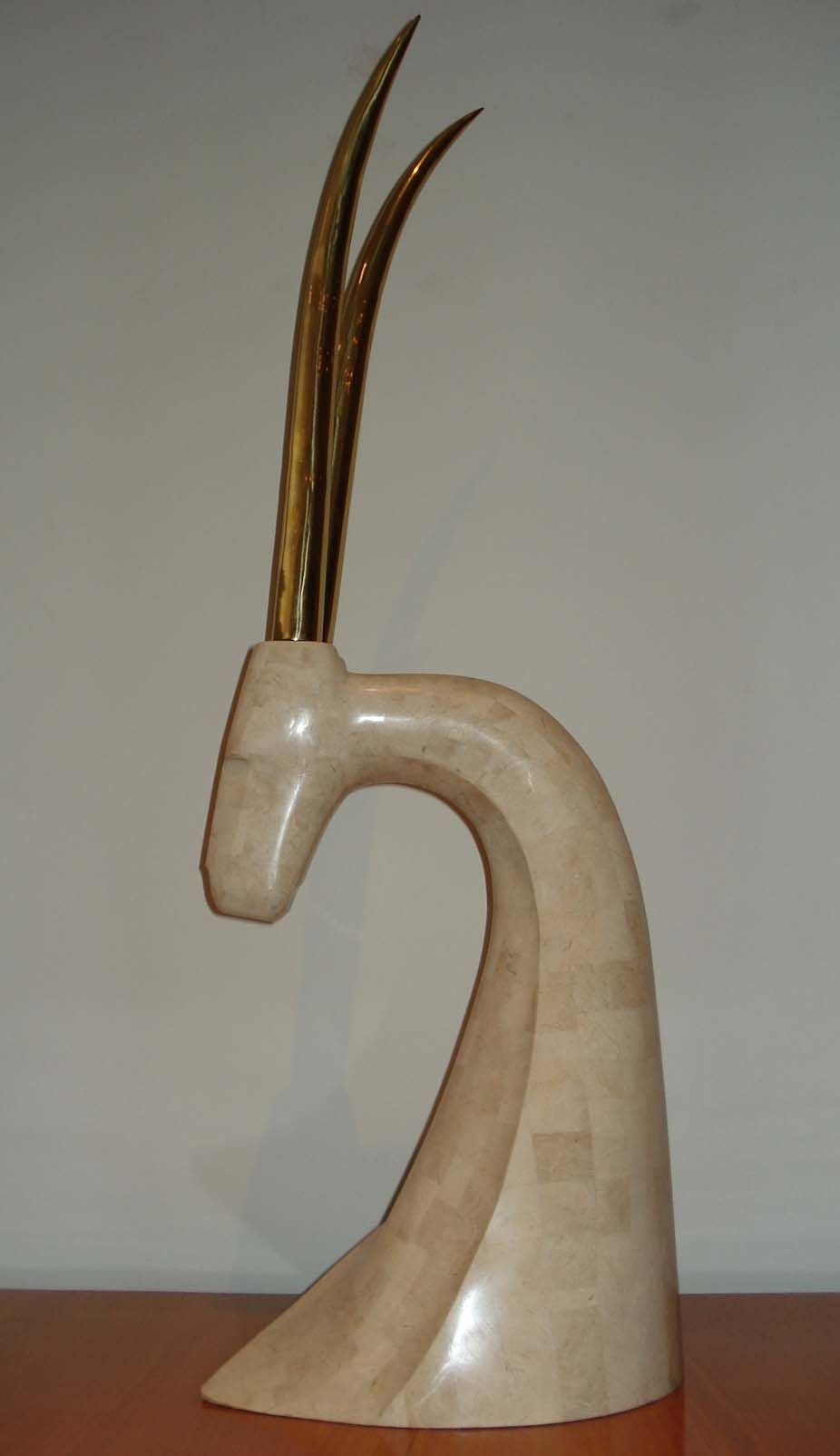 Antelope`s head wrapped in fossilized stone with brass antlers . 1