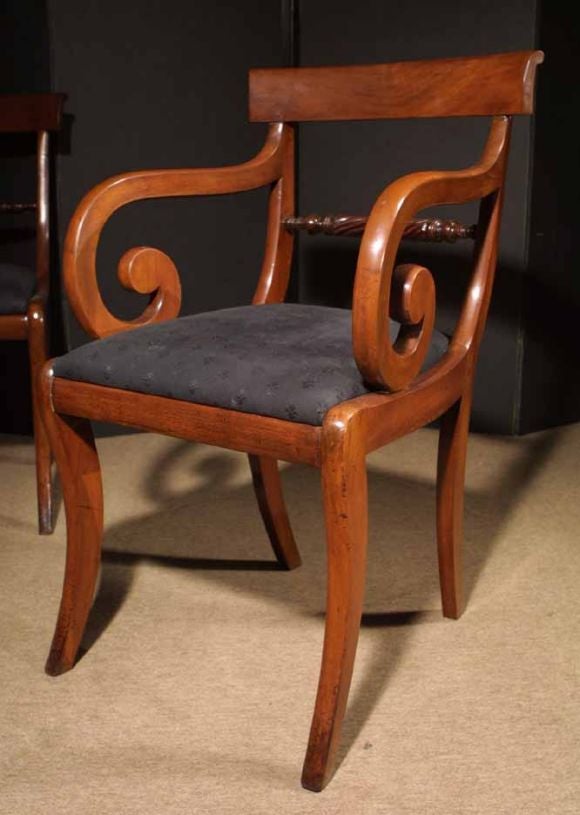 Set ten (2 arms, 8 sides) Regency dining chairs executed in mahogany. The curved crest rail above a carved rope twist back support. The boldly scrolling arms flank a comfortable drop in seat and all raised on elegant sabre legs. The clean, elegant