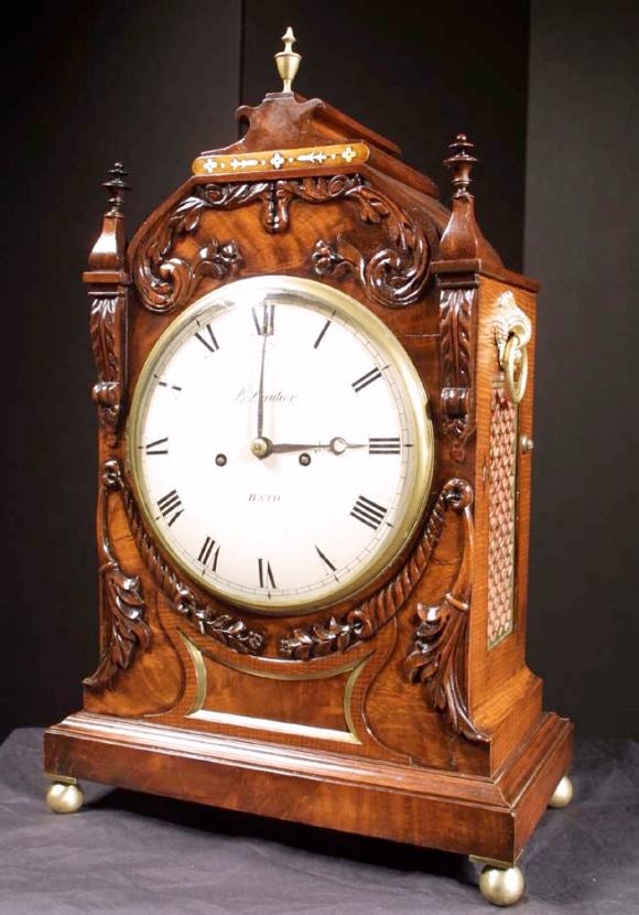 William IV brass inlaid and richly carved mahogany bracket clock. The eight inch painted dial, signed B Lautier of Bath, with strike/silent lever, roman numbers and blued steel hands. The twin fusee movement with shaped plates and striking on a