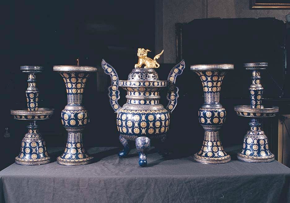 Rare Canton enamel five piece temple garniture decorated in gold stylized Shou characters (meaning long life) on a dark blue ground. Signed on the underside of the central incense burner by a series of characters which translate to â??I Ho Hsiang