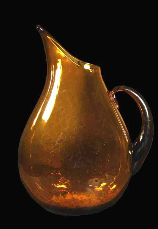 Amber glass pitcher by Blenko. The Blenko Glass Company was the first United States company to produce mouth-blown sheet glass, using what is called the 