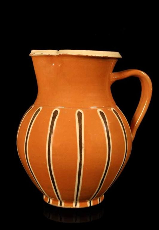 Peach glazed pottery pitcher with gilt reticulated decoration. Marked 