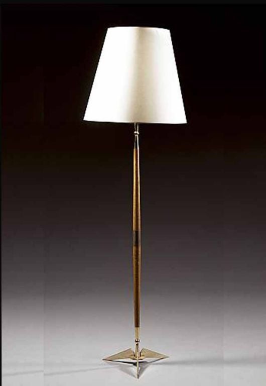 # P556 - Mid-Century Modern Beechwood floor lamp with gilt metal details including the collar and tripod splayed legs. Note the clean design which is a feature of the period.
French, Circa 1950's

See similar examples of lamps and lighting on our