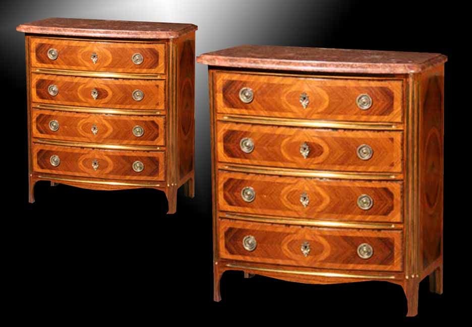 PAIR Regence inspired bow front, marble top, parquetry commodes executed in beautifully matched Kingwood and Tulipwood. All embellished with brass moldings including the rounded fluted corners. Note the four graduated drawers, each with geometric