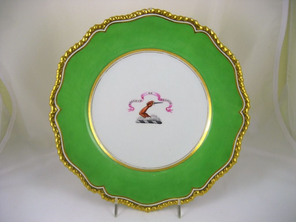 A porcelain dinner plate, part of a service made for the O'Brien family by Flight, Barr, & Barr porcelain. <br />
<br />
Features a gilded gadrooned border and a apple green ground color, with a central panel containing the heraldic crest of the