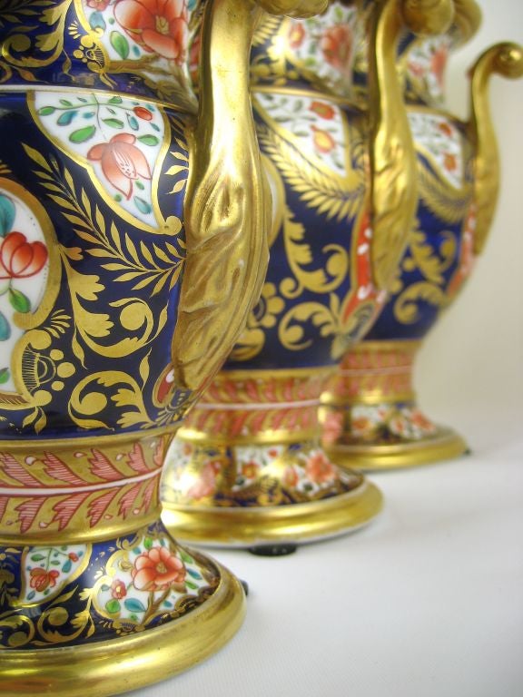 An exemplary decorative garniture of 5 Spode vases, constructed of Josiah Spode's revolutionary, pure white Bone China body, and embellished with  pattern No. 1216 in the Imari taste of the Regency period. <br />
<br />
The garniture consists of