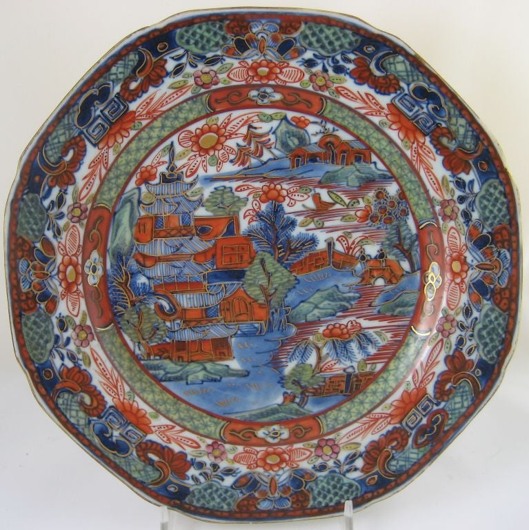 A beautiful pair of Chinese export underglaze blue-painted dinner plates from the late 18th century, with enameled decoration added upon arrival in Europe, by artisans there. These highly collectible pieces have a rustic look, with the rudimentary