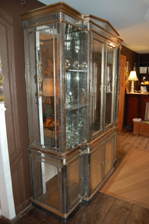 Hollywood luxe at its best, photos do not do this piece justice.<br />
This mirrored cabinet could have been very comfortable in Carol Lombards' bedroom or Jean Harlows' ah... if this piece could talk. Two slight stress cracks silver leaf and
