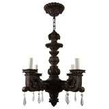 A dark carved wood chandelier
