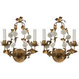 A pair of two arm sconces with porcelain flowers