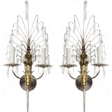 A pair of two arm silver and brass crystal sconces