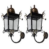 A pair of dark bronze and black cast iron large exterior sconces